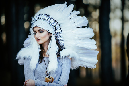 Artistic portrait of young beautiful woman in woods. Shallow depth of fieldの写真素材