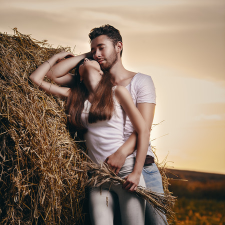 Artistic portrait of young couple at countrysideの写真素材