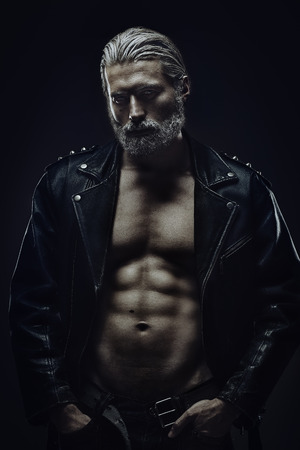 Artistic portrait of muscular mid aged handsome man with gray hairの写真素材