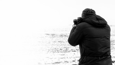 Photographer shooting winter landscape. Lots of copy space