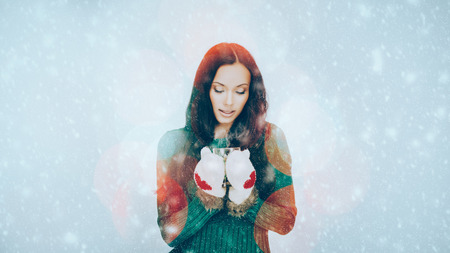 Artistic portrait of gorgeous brunette with hot drink. With blurred lights