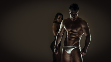 Artistic portrait of young athletic man and womanの写真素材