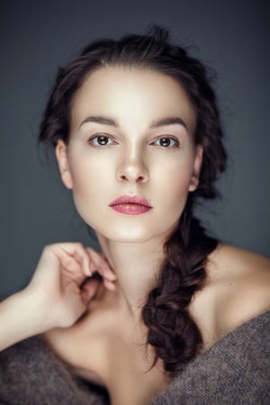 Fashion portrait of gorgeous young brunetee woman.Chaos hair style with braid. Shallow depth of...