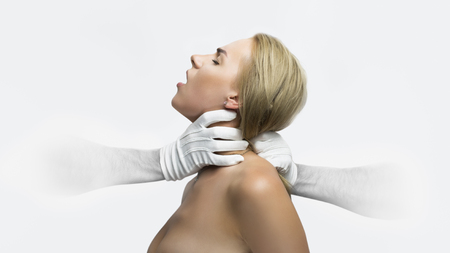 Hands of man from nowhere in white gloves holding woman's neck. Shallow depth of fieldの写真素材