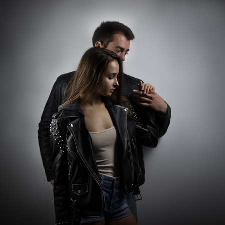 Young beautiful couple hugging in studio. Shallow depth of fieldの写真素材