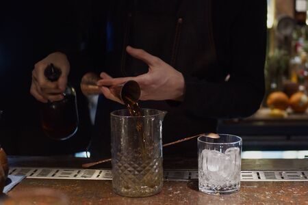 Pouring alcohol in glassの写真素材