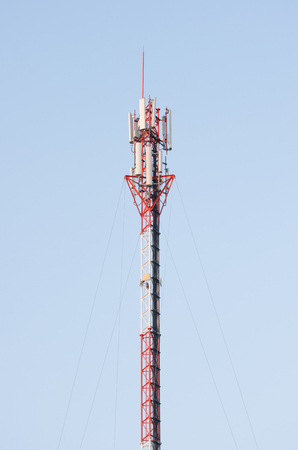 Telecommunication tower. Cell phone signal tower on blue sky backgroundの写真素材