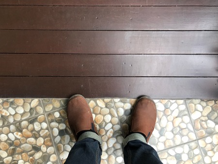 People standing on wooden floor and tile floor.の写真素材