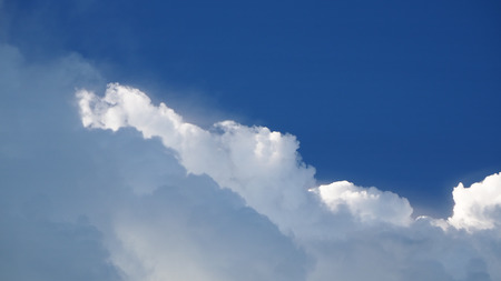 Blue sky background with cloudsの写真素材