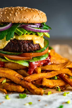 Homemade plant based burger with sweet potato fries around. Vegan.の写真素材