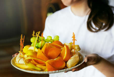 waiter woman holding fruit plate at wedding banquet. summer warm. close up