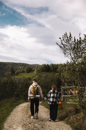 Couple walking in mountain forest green hillsの写真素材