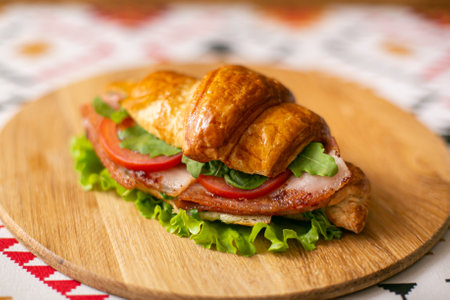 Croissant on a gray plate on a wooden background, top viewの写真素材
