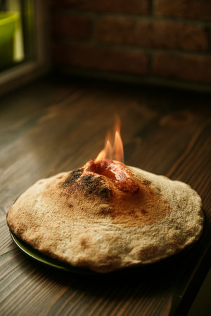 Pizza Volcano with fire. Gorgonzola cheese, cherry tomatoes, fresh vegetables, and spices. On a...