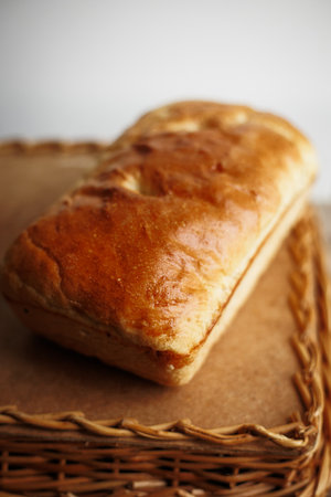 Crispy freshly baked homemade bread on a wood tableの写真素材