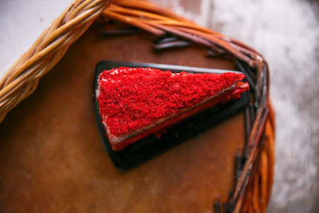triangle piece of red velvet cake on round plateの写真素材