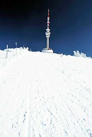Praded hill with TV transmitter in winter Jeseniky mountains with clear skyのeditorial素材