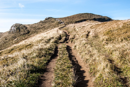 hiking trail to Chleb hill on mountain meadow with small rocks and clear sky in autumn Mala Fatra mountains in Slovakiaの写真素材