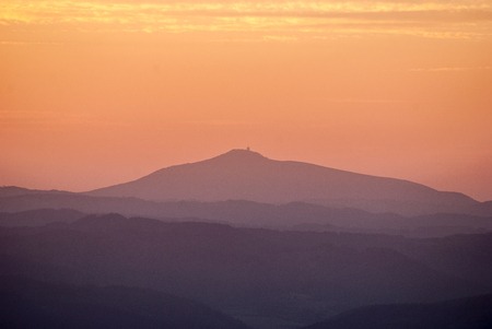 Lysa hora hill in Moravskoslezske Beskydy mountains from Horna luka hill in Mala Fatra mountains  during sunset with colorful skyの写真素材
