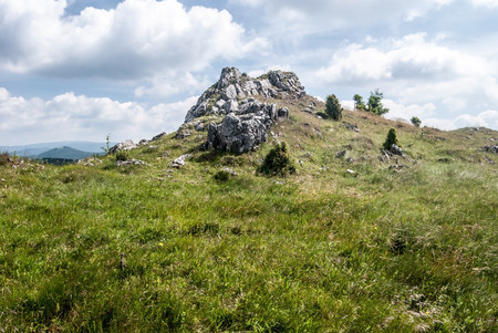 mountain meadow with few rocks and stones and blue sky with clouds on Skalky hill in Mala Fatra mountains in Slovakiaの写真素材
