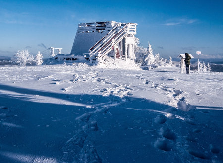 Velka Raca (Wielka Racza) hill summit with view tower and snow in Kysucke Beskydy (Beskid Zywiecki) mountains on slovakian - polish borders during freezing winter day with blue skyのeditorial素材