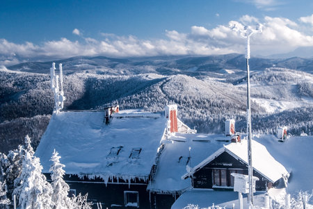 freezing winter day on Wielka Racza hill in Beskid Zywiecki mountains on polish - slovakian borders with chalet, hills on the background and blue sky with cloudsのeditorial素材