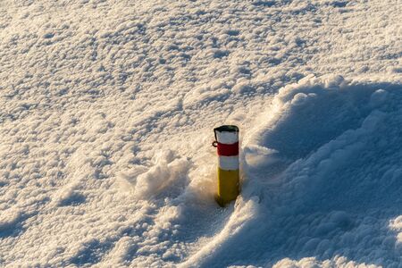 red marked hiking trail cairn with snow around in winter Martinske hole in Mala Fatra mountains in Slovakiaの写真素材