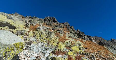 Autumn Vysoke Tatry mountains above highest part of Furkotska dolina valley in Slovakia with rocks,...