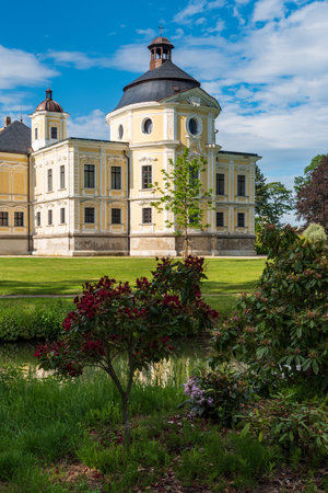Kravare castle wirth Kaple sv. Michala chapel and flowering rhododendron, creek and blue sky with few clouds in Czech republicのeditorial素材