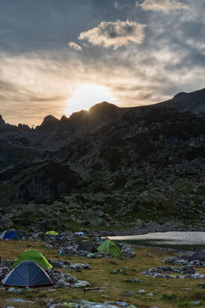 Beautiful sunset above peaks from camping area near Bucura lake in Retezat mountains in Romaniaの写真素材