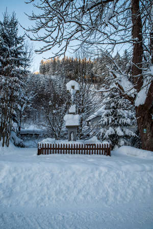 Cruxifix in winter landscape with snow, trees and clear sky on Bebek above Moravka village in Moravskoslezske Beskydy mountains in Czech republicの写真素材