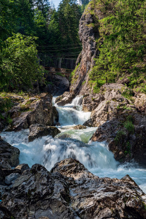 Wild Varinka river with rocks around and stones on Vratna dolina valley near Terchova in Mala Fatra mountains in Slovakiaの写真素材