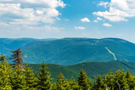 View to Dlouhe side from Spaleny vrch hill in Jeseniky mountains in Czech republic during beautiful day with blue sky and cloudsの写真素材