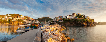Panoramic view of harbour with vessels, boats and lighthouse in Bali at sunrise, Crete, Greeceの写真素材