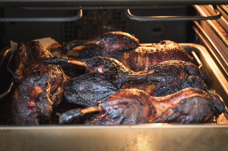 roasted crispy duck in roasting pan in ovenの写真素材