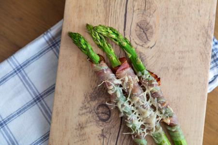 Grilled green asparagus wrapped with bacon and parmesan cheese の写真素材