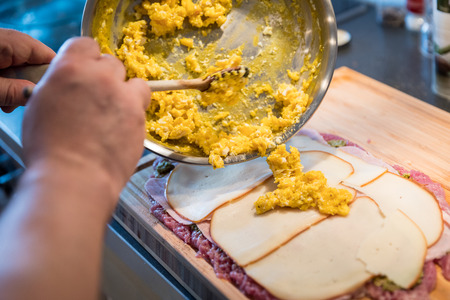 Preparation of delicious homemade pork tenderloin roll with egg, ham and smoked cheeseの写真素材