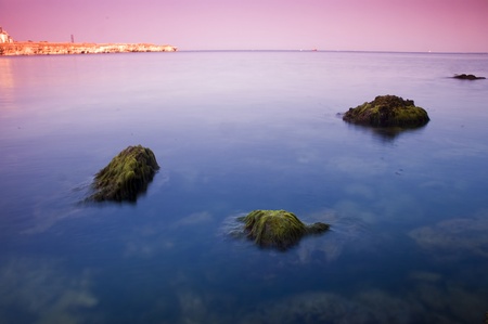 Sunset over the black sea with rocky coastline