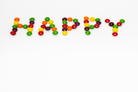Happy sign made of colour lentil candiesの写真素材