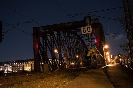Old rusty iron bridge. Night view. A bridge over the river Vltava.の写真素材