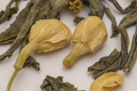 Macro of Chinese jasmine green tea on white paperの写真素材