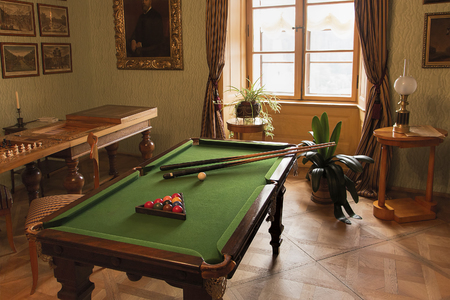 Rozumberk Castle (south of Prague), Czech Republic - August 2, 2015: The historical pool or billiard table and other games in classical Biedermeier style interior from the beginning of 19. century illustrating the life style of rich people of that time inのeditorial素材