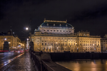 The beautiful National Theatre on the banks of the Vltava River in Prague at night.の写真素材