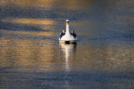 Prague, Czech Republic - October 15, 2016: tourists on a swan boat on river Vltava enjoying autumn afternoon in the historical city. の写真素材