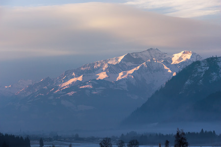 Austria alps, high mountain ridge in the misty morning, winter landscape moodの写真素材