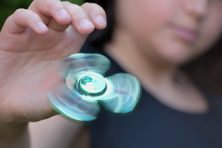 Playing with fidget spinnerの写真素材