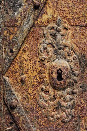 Old rusty iron door, vintage antique grunge background.の写真素材
