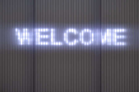 WELCOME. Writing on a Wall with illuminated lettering.の写真素材