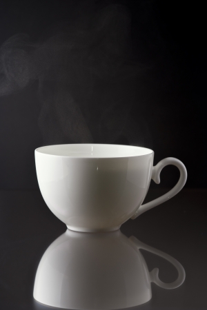white cup on black background with reflectionの写真素材