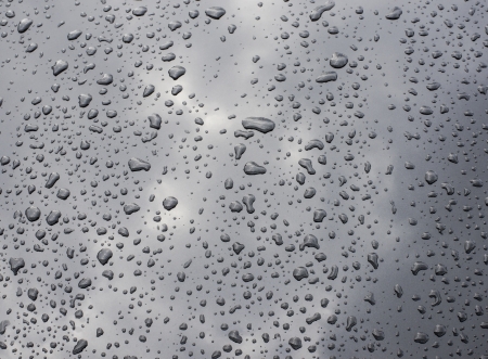 waterdrops on black car paint as texture or backgroundの写真素材
